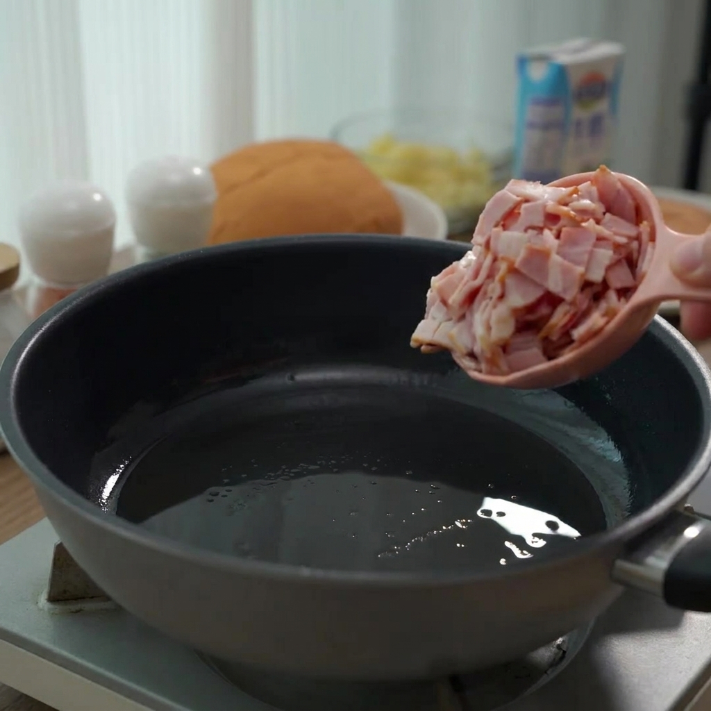 Pezzetti di pancetta cruda versati in una padella per essere cotti.