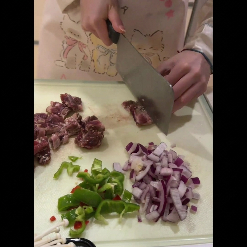 Costine di manzo fresche tagliate con cura in pezzi uniformi e delle dimensioni di un boccone su un tagliere.
