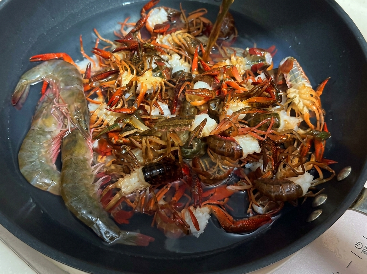Gamberi di fiume freschi sbollentati in una padella con acqua e vino da cucina.