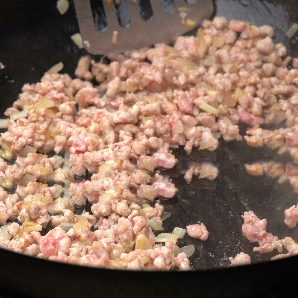 Carne macinata che rosola in padella con la cipolla.