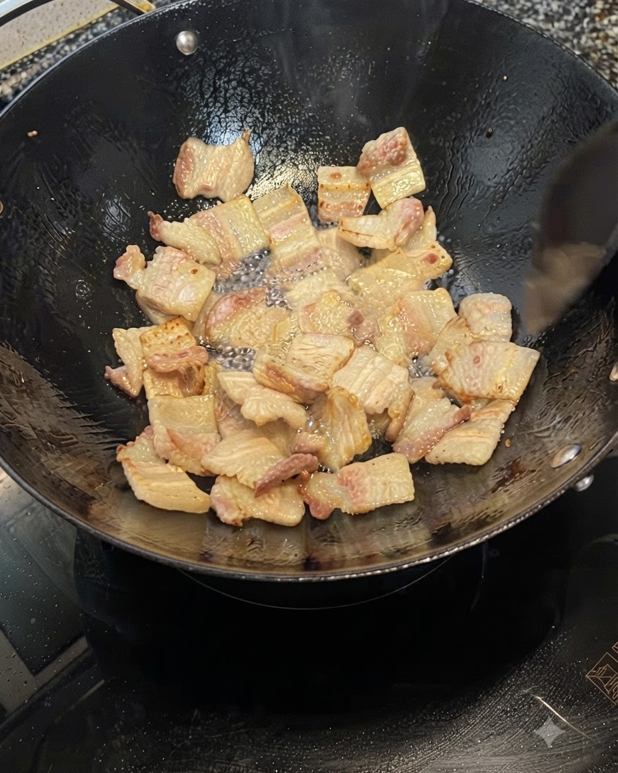 Fette di pancetta di maiale che friggono in un wok, rilasciando grasso e diventando marroni dorate.