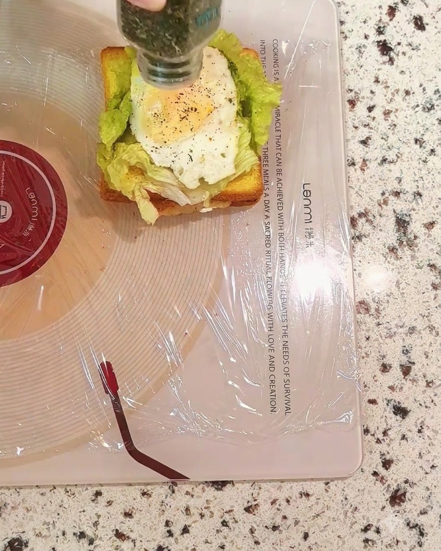Cospargere prezzemolo essiccato da un barattolo sullo strato di uovo del panino.