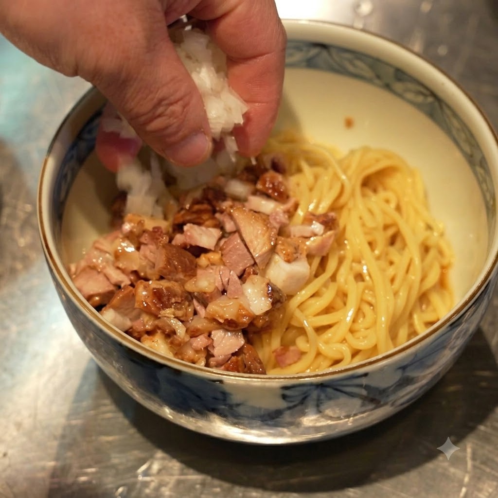 Mano che sparge cipolle bianche a dadini sulla ciotola contenente noodles e carne chashu a dadini.