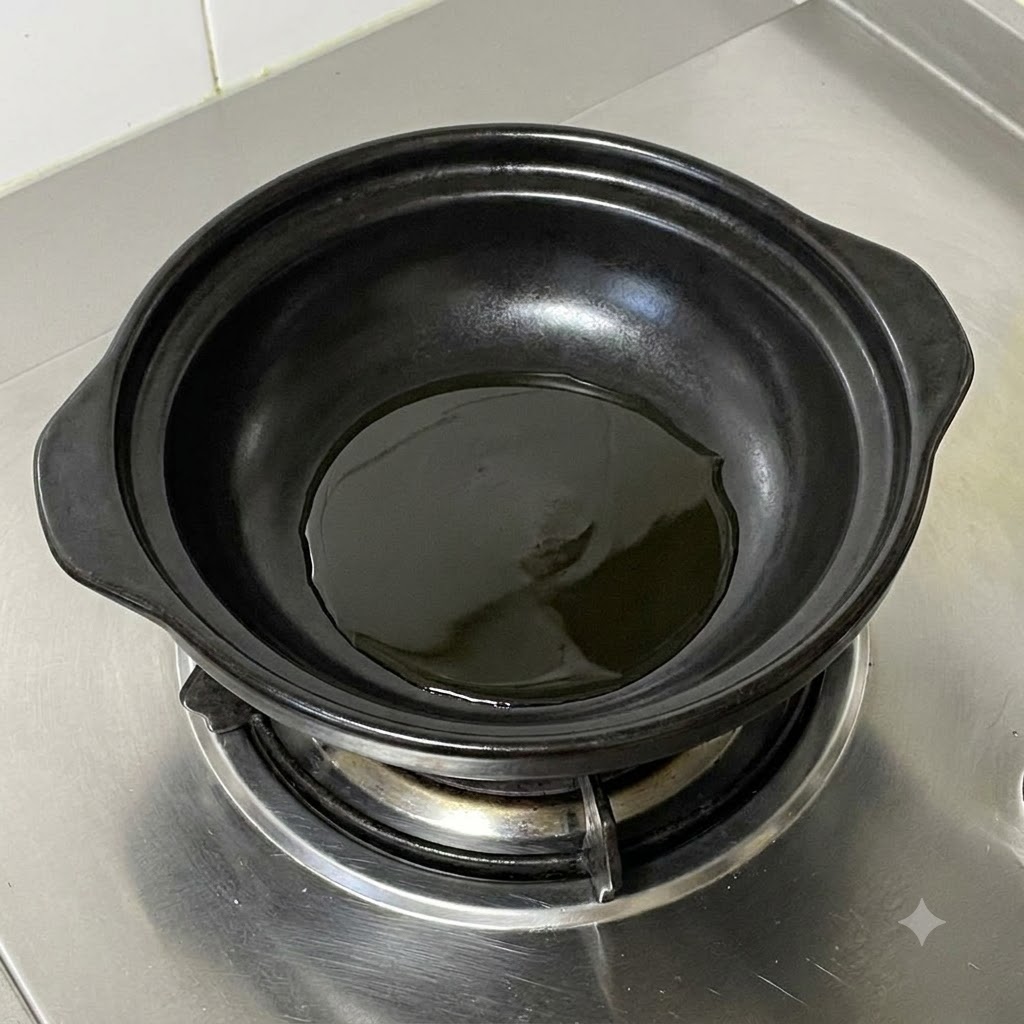Cipollotti tagliati a pezzi che sfrigolano nellolio caldo allinterno di una pentola nera di ceramica.